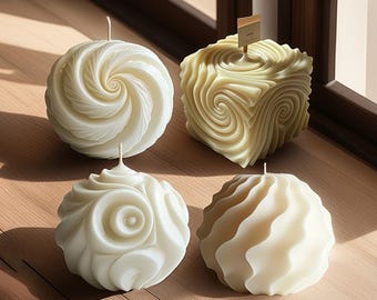 May include: Four decorative candles in various shapes and off-white colors. Two are spherical with spiral designs, one is cube-shaped with a similar pattern, and the last is a round shape with wavy lines. Each candle has a wick.