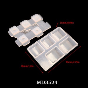 May include: A clear silicone mold with six square cavities, measuring 70mm by 46mm. The mold is designed for making small resin crafts. The mold is labeled "MD3524".