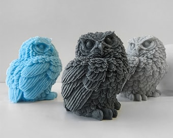 May include: Three owl figurines, one blue, one gray, and one black, with detailed feather patterns.