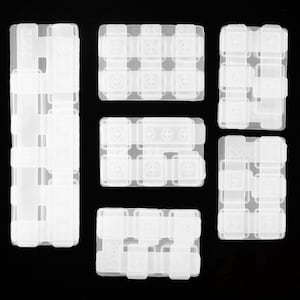 May include: Set of six clear plastic keyboard keycap molds. The molds are rectangular and have different sizes and shapes. They are designed to create custom keycaps for mechanical keyboards.