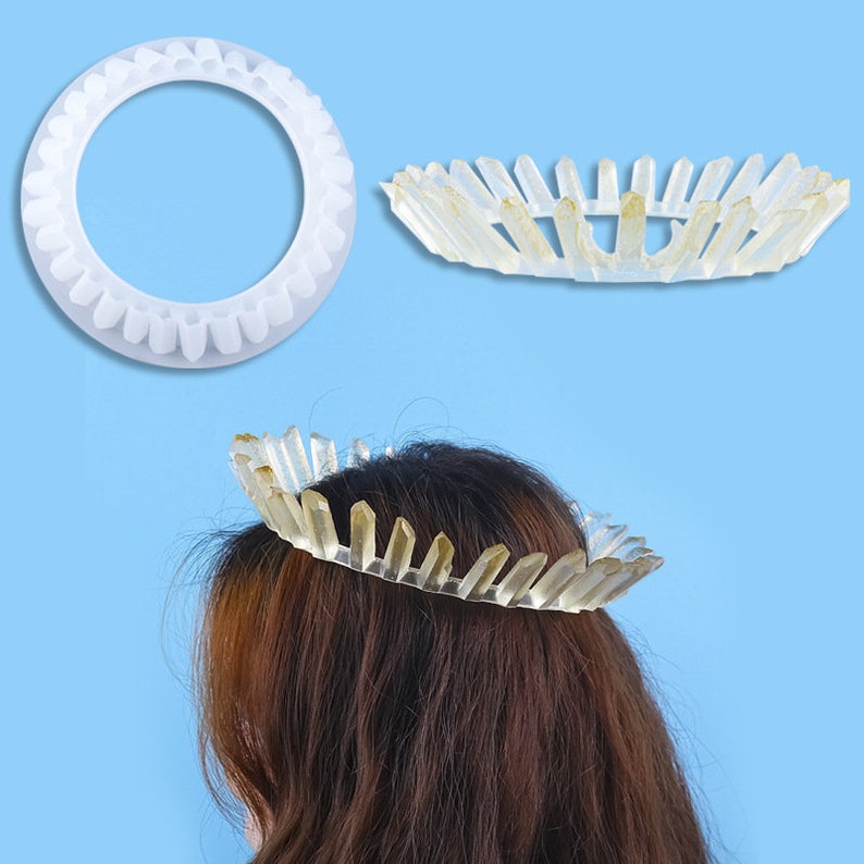 May include: A clear plastic crown with a row of crystal-like points around the edge. The crown is shown on a person's head.
