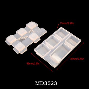 May include: A clear silicone mold for making resin keycaps. The mold is 2.75 inches long and 1.8 inches wide. It has six rectangular cavities for making keycaps. The mold is labeled "MD3523".