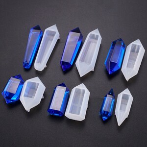 May include: Set of clear silicone molds shaped like pointed crystals, with blue resin casts in some of the molds.
