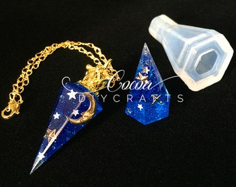 May include: A blue and gold resin pendant with a crescent moon and stars, hanging from a gold chain. The pendant is in a clear silicone mold.