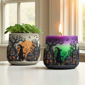 May include: Two Halloween-themed candle holders. One is a planter with green plants, the other a candle with a lit flame. Both feature a spooky village scene with a witch, trees, and a full moon. The candle holder has a gradient of purple and green.
