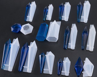May include: A set of 15 silicone molds for making crystal-shaped resin crafts. The molds are in various shapes, including long, pointed, and round. The molds are white and the crystals are blue.