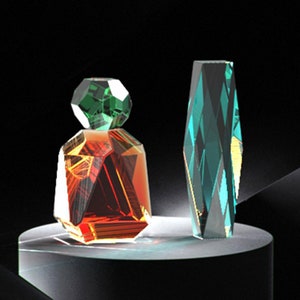 May include: Two glass bottles with geometric designs. The bottle on the left is red and green, while the bottle on the right is blue and green.