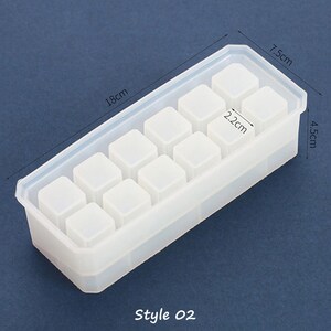 May include: A clear silicone mold with 12 square cavities for making resin crafts. The mold measures 7.5 inches long, 4.5 inches wide, and 1.8 inches tall. Each cavity is 2.2 inches wide. Style 02.