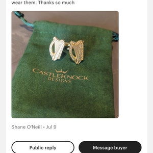 May include: A pair of gold Irish harp cufflinks in a green velvet pouch with the text "CASTLEKNOCK DESIGNS".