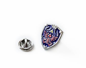 Pin de solapa con escudo Hylian de Zelda, accesorio para videojuegos, joyería inspirada en Zelda, regalo único para jugadores, diseño elegante de escudo Hylian.