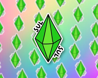 May include: A green diamond-shaped sticker with the word "SUL" written on it in black. The sticker is on a rainbow background.