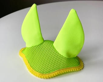 May include: A bright green horse fly bonnet with yellow trim. The bonnet has a mesh design and two large ear covers.