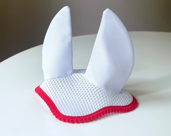 May include: White horse fly bonnet with red trim and mesh ears.