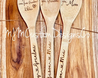 May include: Three wooden spoons with personalized messages. The first spoon says "My favorite treats come from Grandma's Kitchen". The second spoon says "We love you, Grandma". The third spoon says "We love you, Mom".