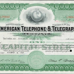 May include: A vintage stock certificate for one share of American Telephone & Telegraph Company, dated November 3, 1952, issued to Bluford E. Atkins. The certificate is printed on green paper with a decorative border and features a globe in the center.