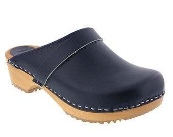 May include: A pair of navy blue leather clogs with a wooden sole and a strap across the top.