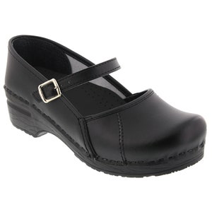 May include: Black leather clog with a buckle strap and a wooden heel.