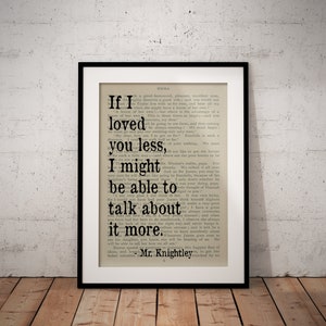 May include: A black framed print of a book page with a quote from the novel Emma by Jane Austen. The quote reads, "If I loved you less, I might be able to talk about it more." - Mr. Knightley.