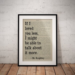 May include: A black framed print of a book page with a quote from the novel Emma by Jane Austen. The quote reads, "If I loved you less, I might be able to talk about it more." - Mr. Knightley.