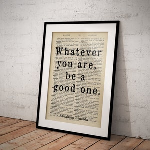 May include: A framed print of a dictionary page with the quote "Whatever you are, be a good one." attributed to Abraham Lincoln.