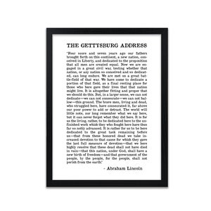 May include: Black and white text on a white background within a black frame. The text is the Gettysburg Address by Abraham Lincoln. The text is centred on the page and is in a traditional serif font.