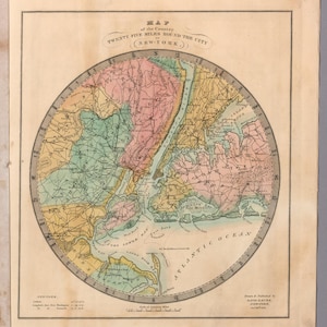 May include: An antique map of New York City and its surroundings, presented in a circular format. The map features colourful land areas and water, with text reading "Twenty Five Miles Round the City (New-York.)". The map is framed.