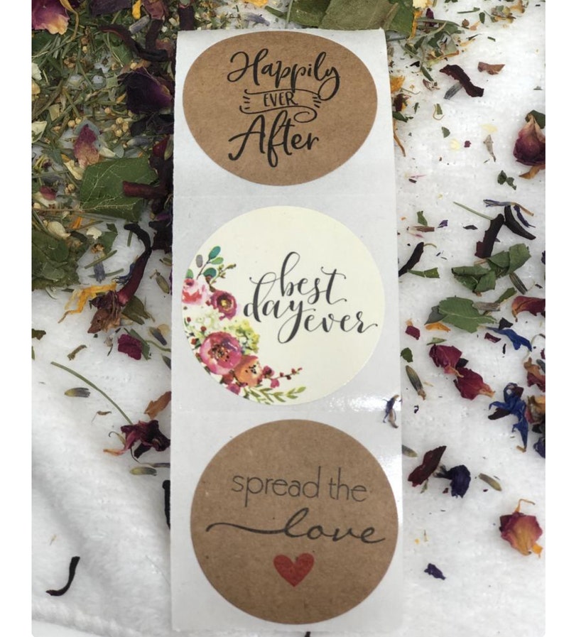 May include: Three round brown and white stickers with wedding-themed text. The top sticker says "Happily Ever After" in black script. The middle sticker has a floral design and says "Best Day Ever" in black script. The bottom sticker says "Spread the Love" in black script with a red heart.