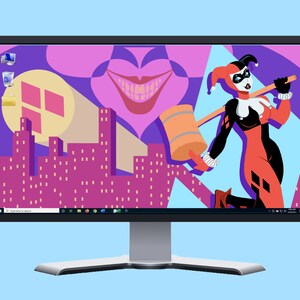 May include: A computer monitor displaying a colorful desktop background featuring a cartoon character in a red and black costume holding a mallet. The background also includes a cityscape and a large, pink, smiling mouth.