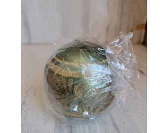 May include: A green Christmas bauble with gold glitter and a floral design.