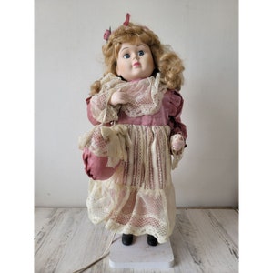 Motionette Spitze rosa Mädchen blonde Puppe animierte Geldbörse