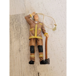 Volunteer firefighter man acts ornament Xmas hero
