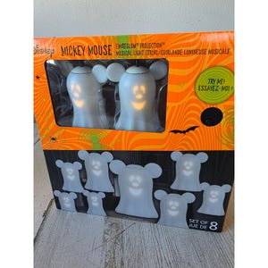 May include: A set of eight Mickey Mouse-shaped musical light string decorations. The box features two larger lights and six smaller lights. The lights are white with a yellow glow and are designed for Halloween.