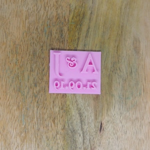 May include: Pink rubber stamp with the letters J & A and the date 21.09.19.