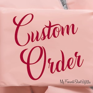 May include: A pale pink package with the words "Custom Order" in a burgundy script font. The text "My Favorite Shirt By Mia" is at the bottom in a smaller, black font. The package is sealed.