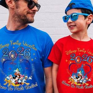 May include: Two matching t-shirts, one blue and one red, with the text "Disney Family Vacation 2026" and a Disney character graphic. The shirts also have the phrase "Where The Magic Begins!"