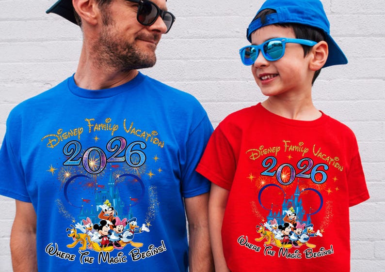 May include: Two matching t-shirts, one blue and one red, with the text "Disney Family Vacation 2026" and a Disney character graphic. The shirts also have the phrase "Where The Magic Begins!"