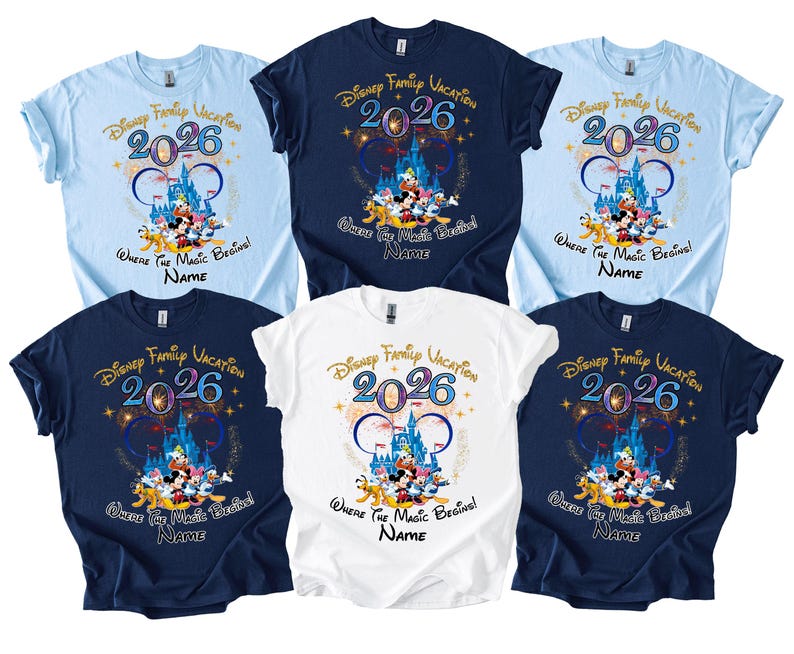 May include: A collection of six short-sleeved t-shirts in various colors: light blue, navy blue, and white. Each shirt features a colorful graphic with the text "Disney Family Vacation 2026" and a castle design with Disney characters. The phrase "Where the Magic Begins!" is also included.