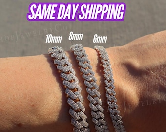 May include: Three silver-toned cuban link bracelets encrusted with small clear stones. The bracelets are labeled with widths of 10mm, 8mm, and 6mm, showing the variation in size between the three pieces of jewelry worn on the wrist.