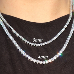 May include: Two silver tennis chains with cubic zirconia stones. The chain on top is 3mm wide and the chain on the bottom is 4mm wide.