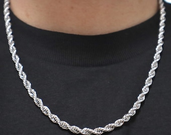 May include: A silver rope chain necklace. The chain is made of a thick, twisted rope design.