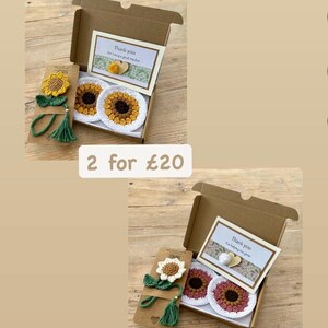 May include: Two gift sets featuring crochet sunflower bookmarks with green tassels and matching circular coasters in a cardboard box. Each set includes a card with the text Thank you for being a great teacher or Thank you for helping me grow.
