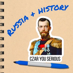 May include: A sticker with a portrait of a man in a military uniform. The text "CZAR YOU SERIOUS" is below the portrait. The text "RUSSIA + HISTORY" is written in blue marker on a brown notebook.