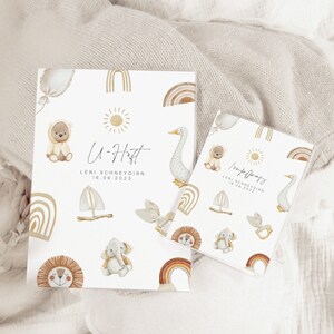 May include: Two white cards with a light brown background and illustrations of animals and rainbows. The text on the cards reads "U-Haft Leni Schneydrin 16.06.2023" and "Willkommen Leni Schneydrin 16.06.2023".