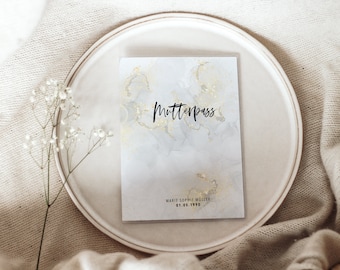 May include: A white card with gold accents and the text "Mutterpass" in black. The card also includes the text "Marie Sophie Muller 01.05.1990" in black.