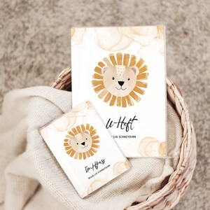 May include: Two small notebooks with a lion illustration on the cover. The larger notebook says "u-Heft" and the smaller notebook says "In-Pass".