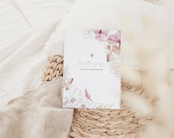 May include: A white card with a floral design in shades of pink and brown. The card has the text "mutterpass" and "HAILEY SCHNEYDVIRN" printed on it.
