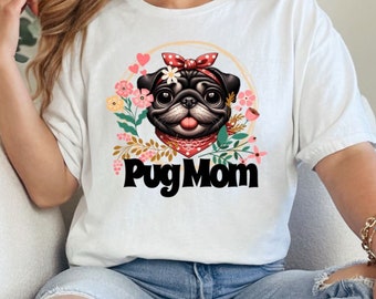 May include: White t-shirt with a black and white pug wearing a red bandana and surrounded by pink and green flowers. The text "Pug Mom" is printed in black below the pug.