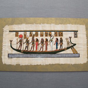 May include: An Egyptian papyrus painting depicting a boat with figures, likely gods or pharaohs, in vibrant colors. The figures are in various poses, with detailed clothing and accessories. The boat is green and black, with oars and a decorative prow.