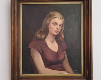 May include: An oil painting in a dark brown wooden frame depicting a person with shoulder-length blonde hair wearing a short-sleeved maroon top. The subject is positioned against a dark gray background, with the signature NSILL visible in the corner.