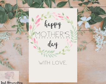 May include: A white card with a floral wreath design and the text "happy mother's day with love."